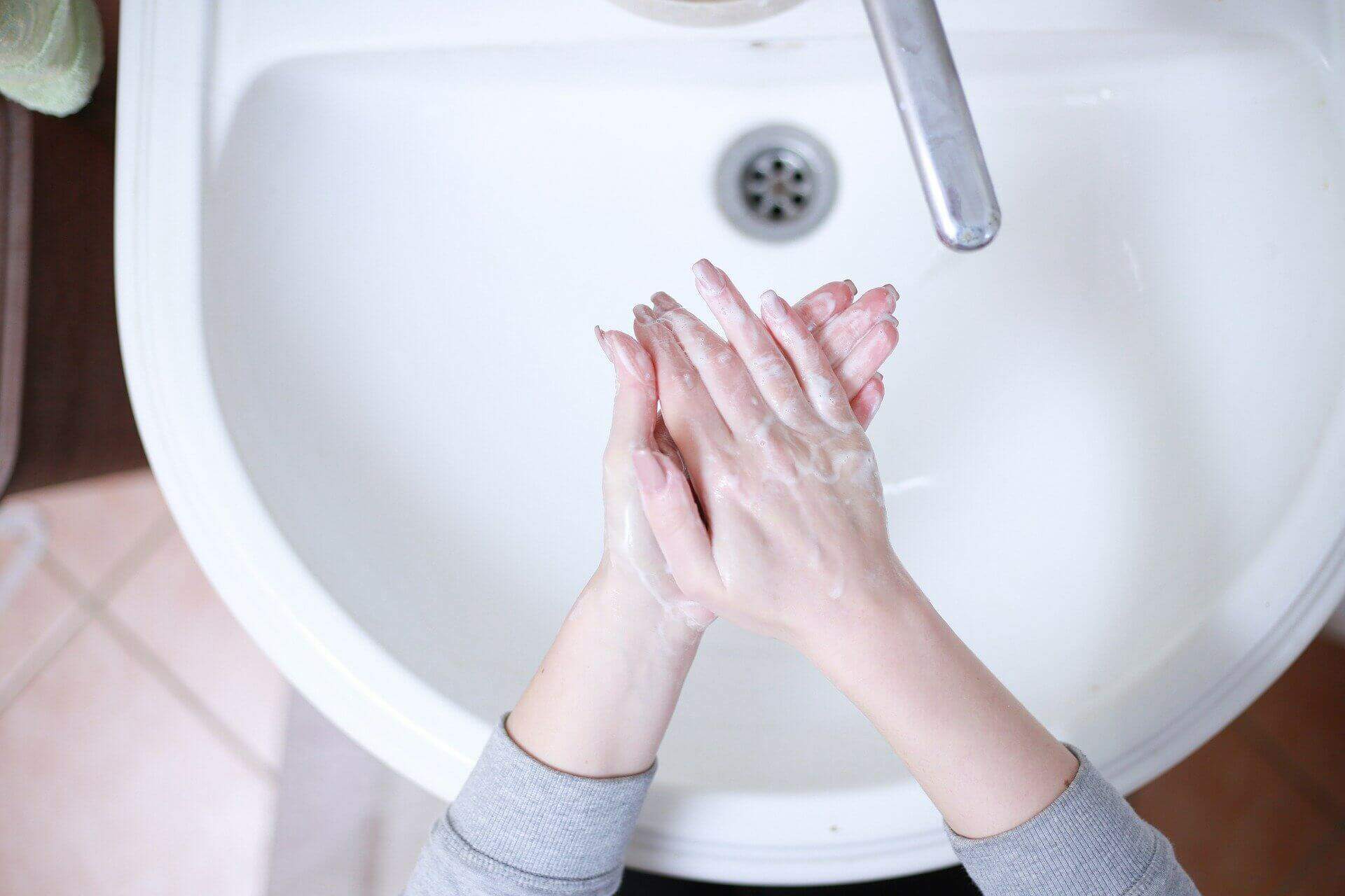Pessoa lavando as mãos. Conteúdo sobre direito a agua, saneamento e higiene