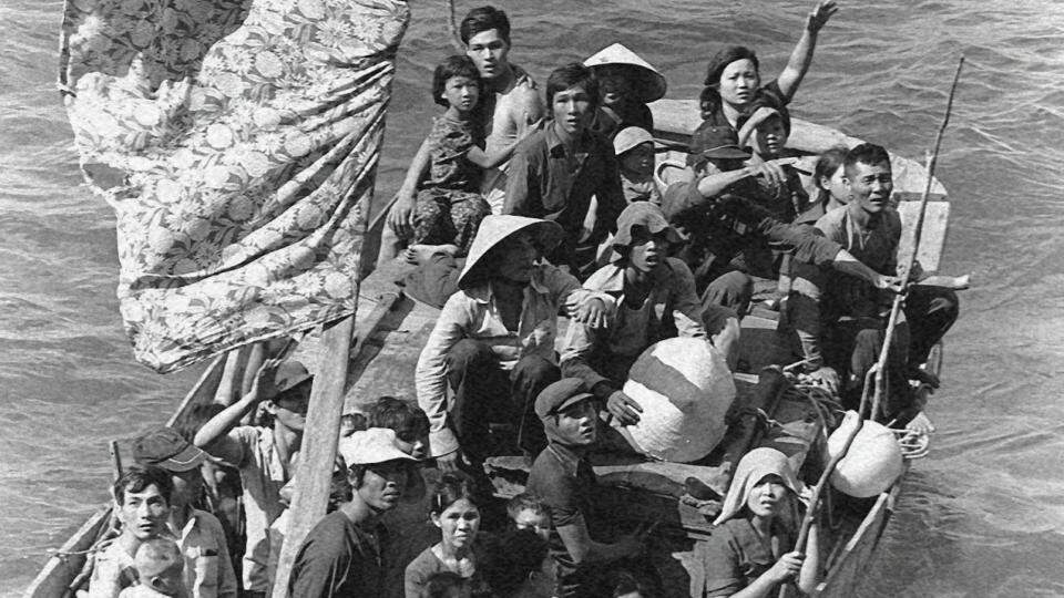 Imagem de pessoas em um barco pedindo refúgio, representando a história dos direitos dos refugiados e migrantes