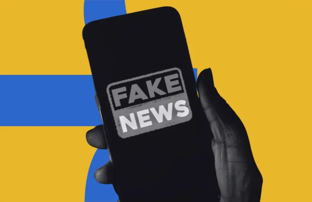 Capa de blogpost contendo um celular escrito na tela "fake news"