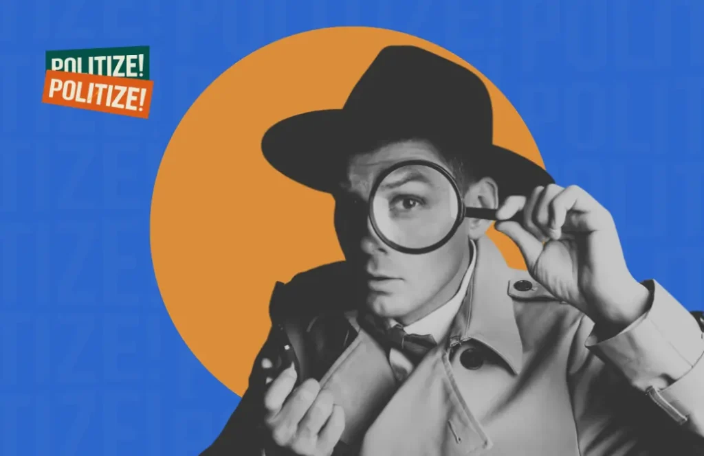 Homem com chapéu de detetive segurando uma lupa e olhando atentamente.